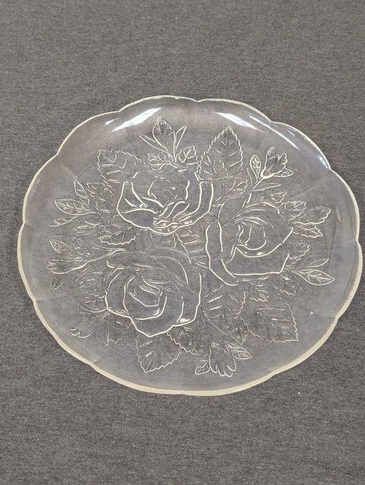 Clear glass plate with an embossed design of three large roses and leaves.