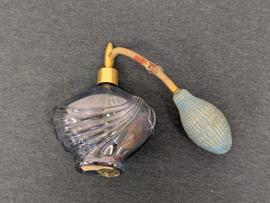Blue swirling glass perfume bottle with a fabric atomizer bulb attached.
