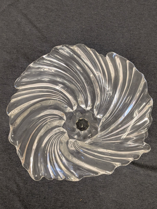 Top down view of a clear glass bowl with a mesmerizing swirl pattern.