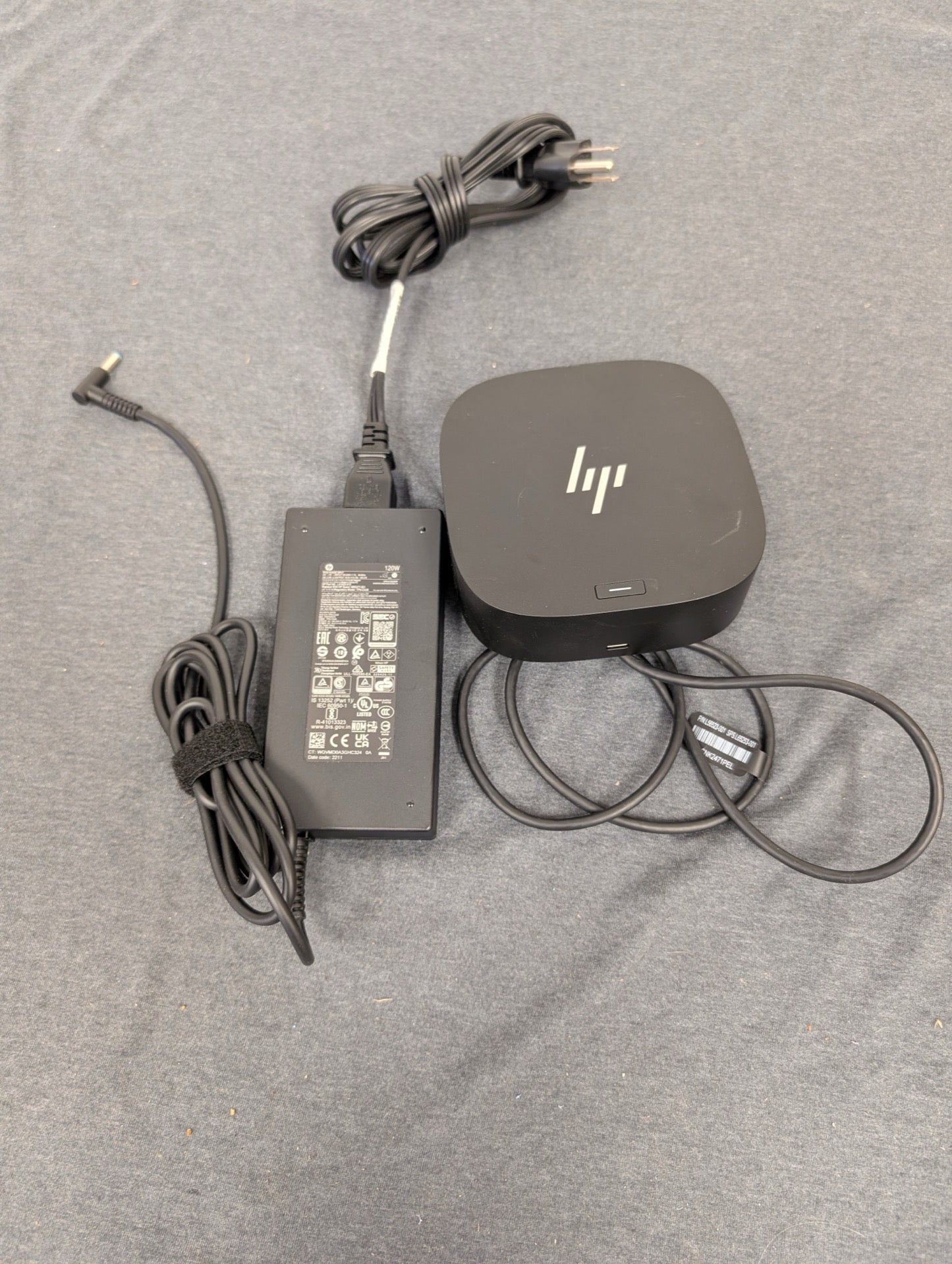 HP Thunderbolt dock and power adapter on grey background