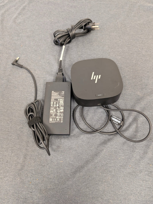 HP Thunderbolt dock and power adapter on grey background