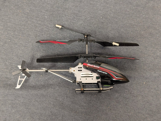 Black and red Black Spider RC helicopter lying on its side