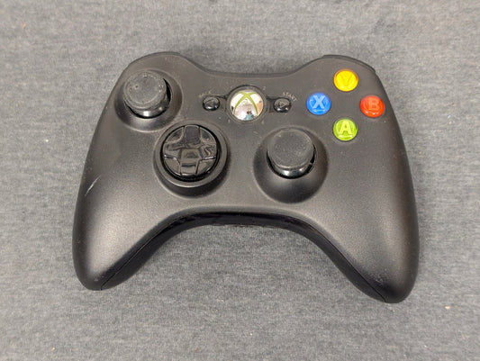 Black Xbox 360 controller with left thumbstick missing rubber