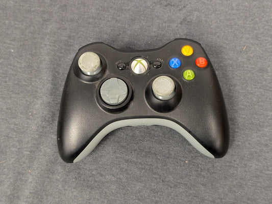 Black Xbox 360 controller with worn grey analog sticks