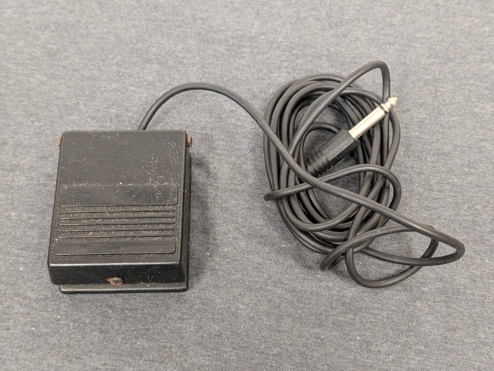 Black square foot pedal with 1/4 inch audio jack