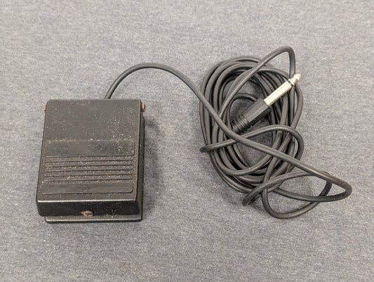 Black square foot pedal with 1/4 inch audio jack