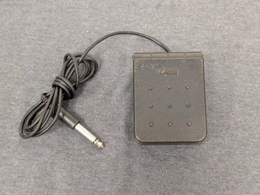 Black Yamaha FC5 sustain pedal with 1/4 inch cable on grey background