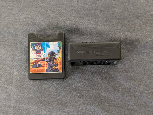 Two black Nintendo DS game holders, one showing a Lego Ninjago image