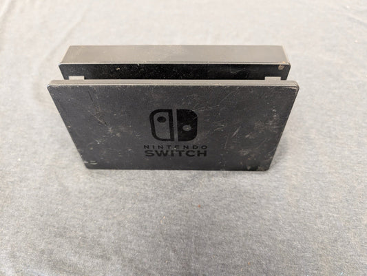 Black Nintendo Switch TV dock showing scuffs and scratches