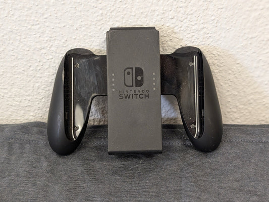 Black official Nintendo Switch Joy-Con grip heavily scratched