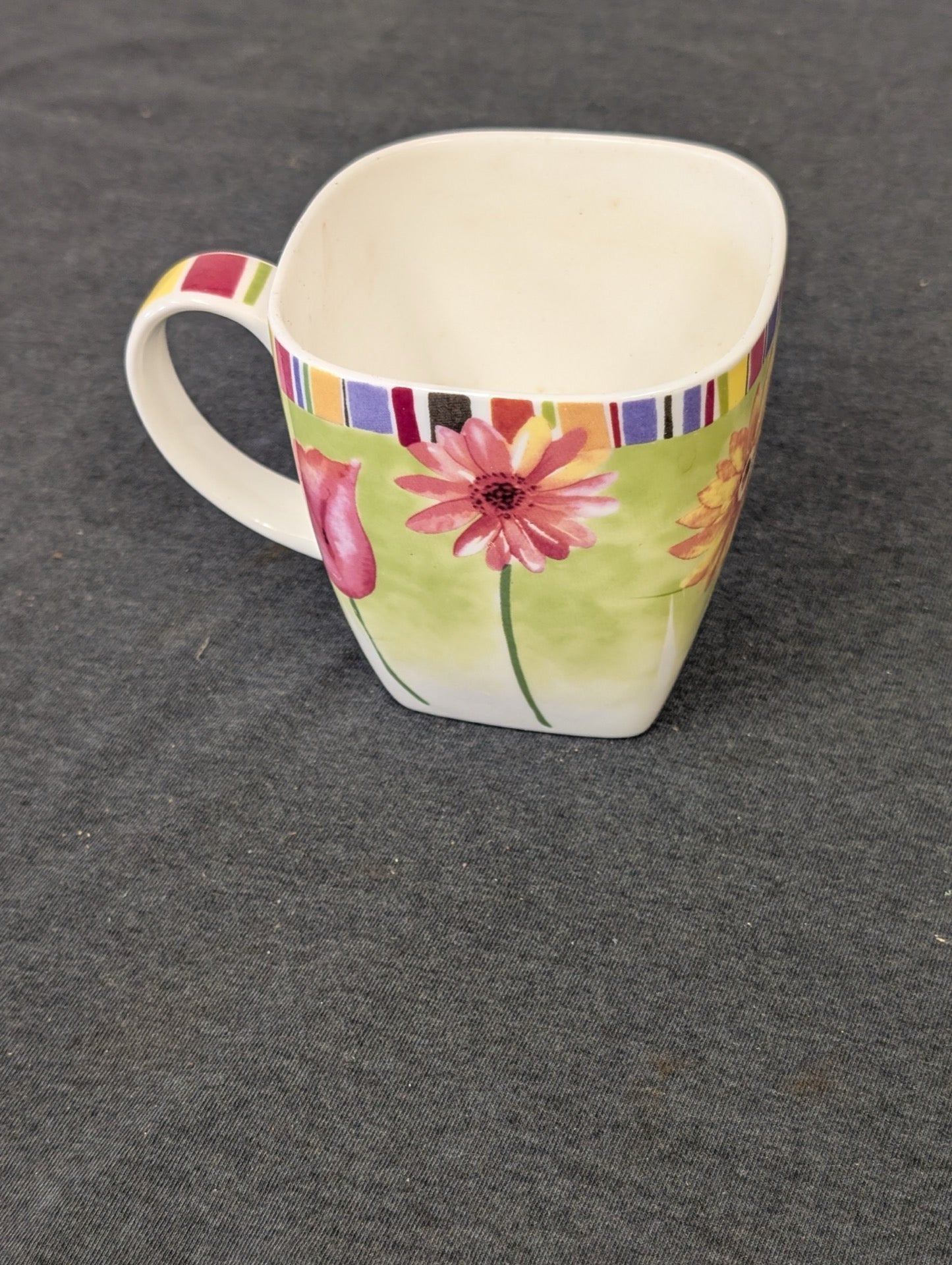 Square shaped ceramic coffee mug with pink and yellow flowers and striped top rim