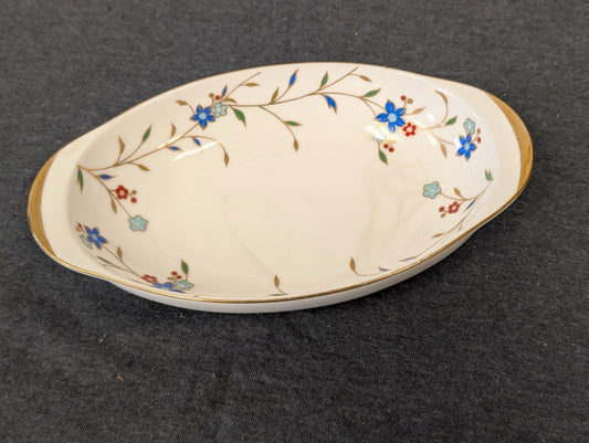 Left-angled view of a vintage Irodori Japan oval porcelain dish with gold trim.