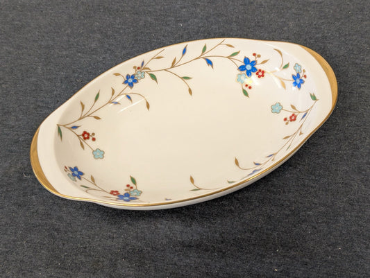 Angled view of a vintage Irodori Japan oval porcelain serving dish with floral pattern.