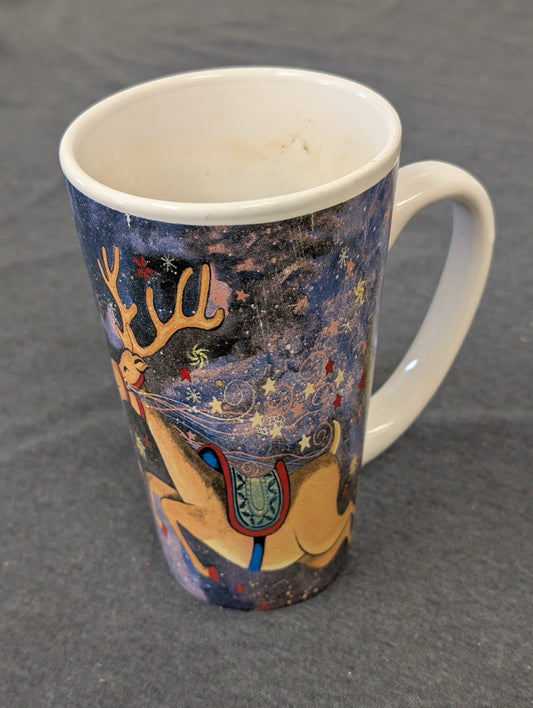 Tall ceramic coffee mug featuring a flying reindeer on a starry night background.