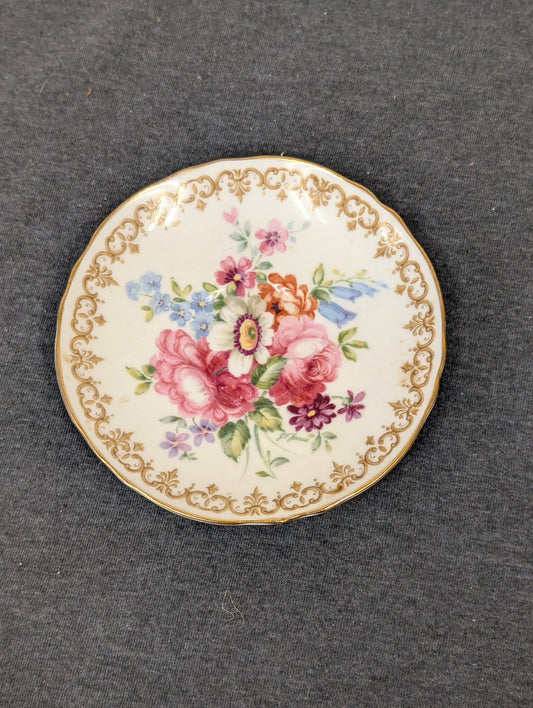 Small vintage plate with floral bouquet and gold border signed J.F. Jones