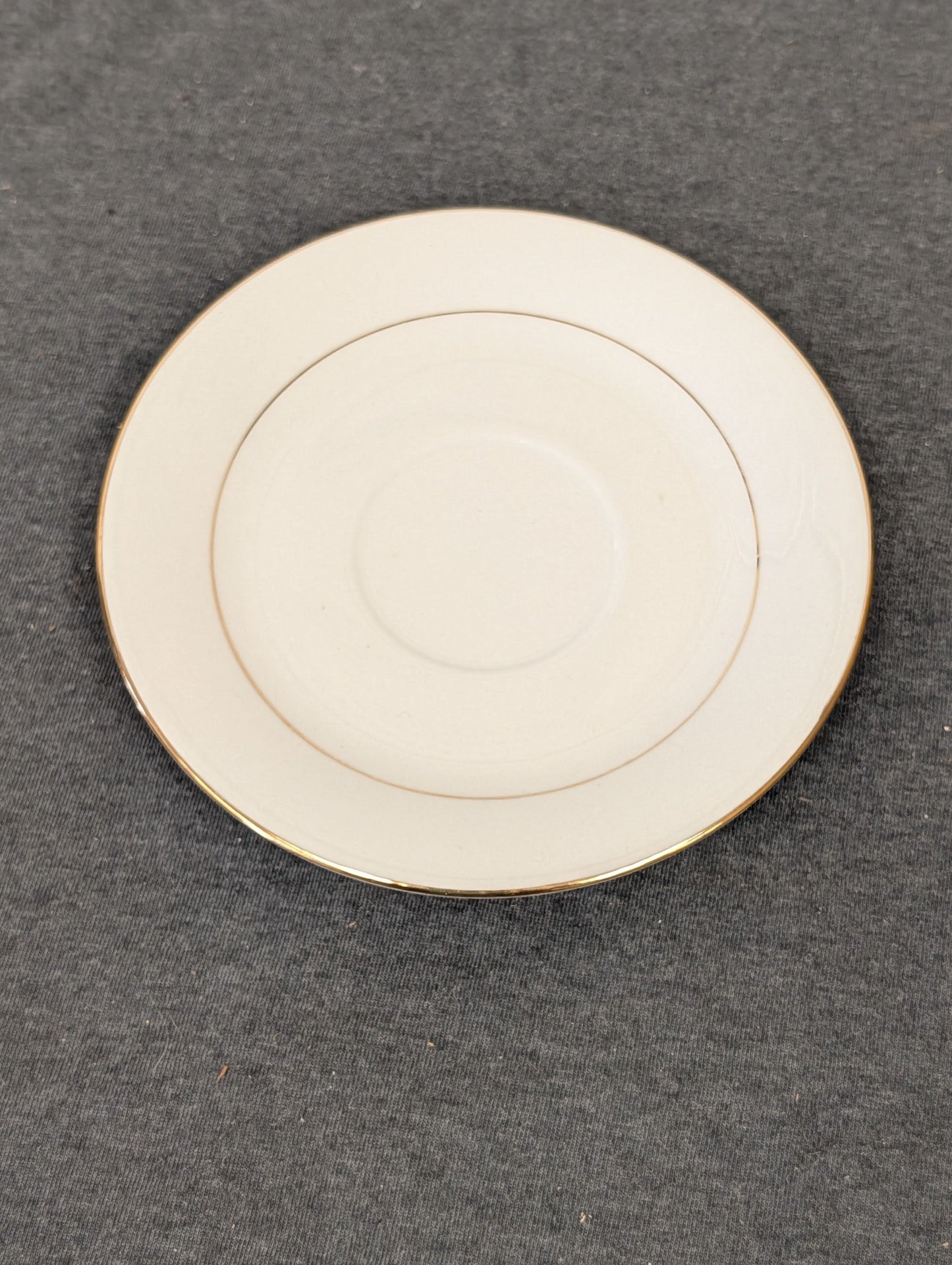 Top view of white Sakura Classic Gold saucer