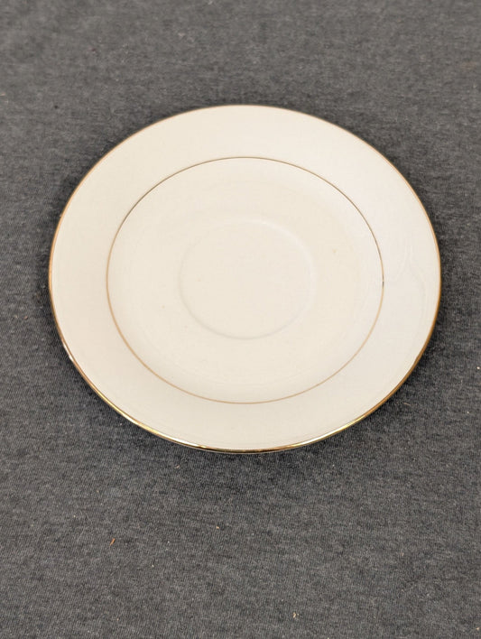 Top view of white Sakura Classic Gold saucer