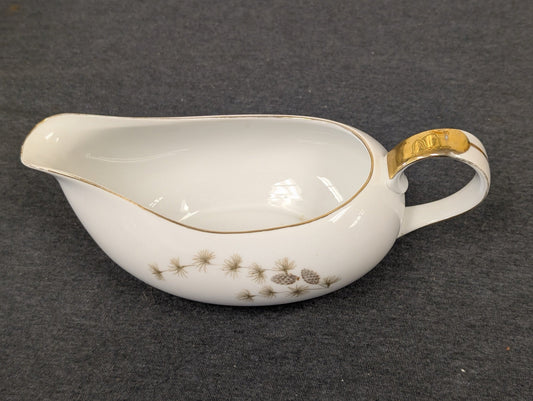 Vintage white porcelain gravy boat with gold handle and pinecone motif