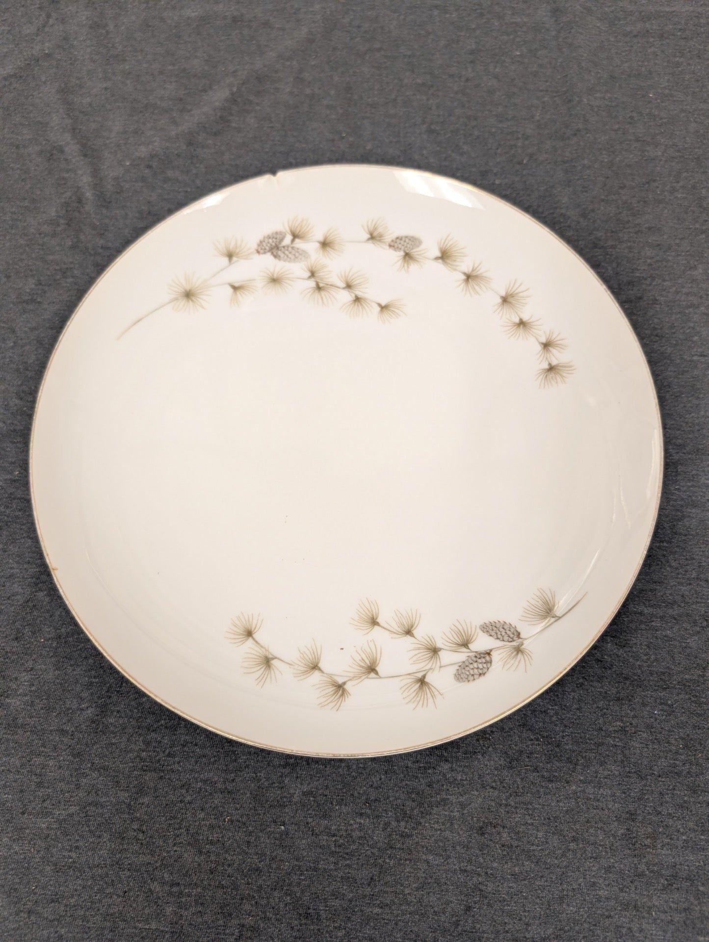 Mikasa Sequoia 6141 plate with pine motif and chip on the left edge