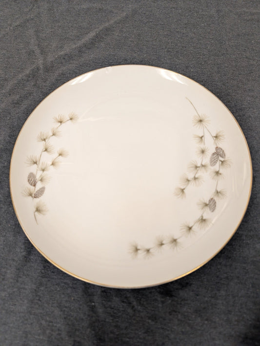 Front of Mikasa Sequoia 6141 plate with top edge chip and pine motif