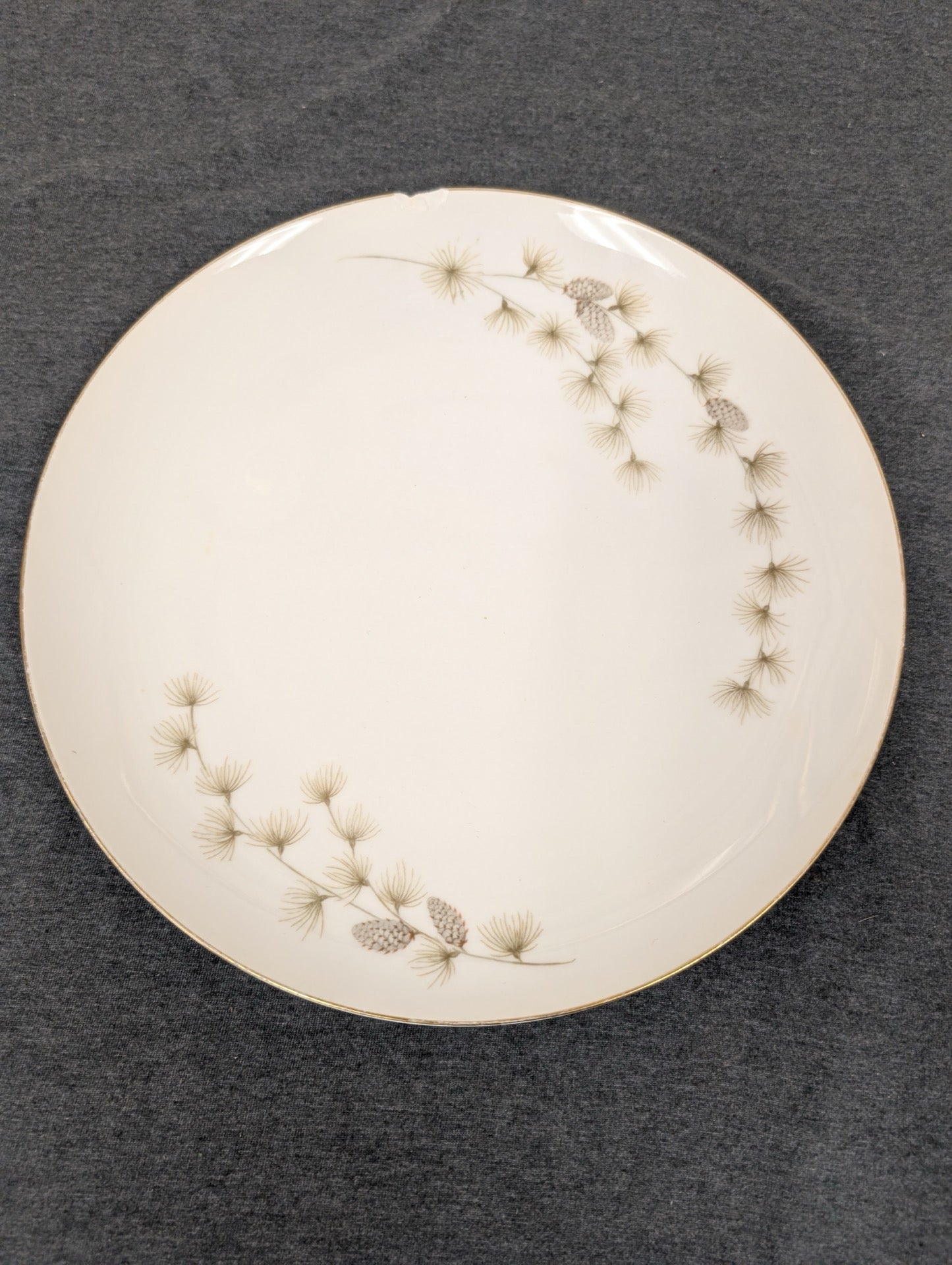 Mikasa Sequoia 6141 plate featuring pine needle motif and small top chip