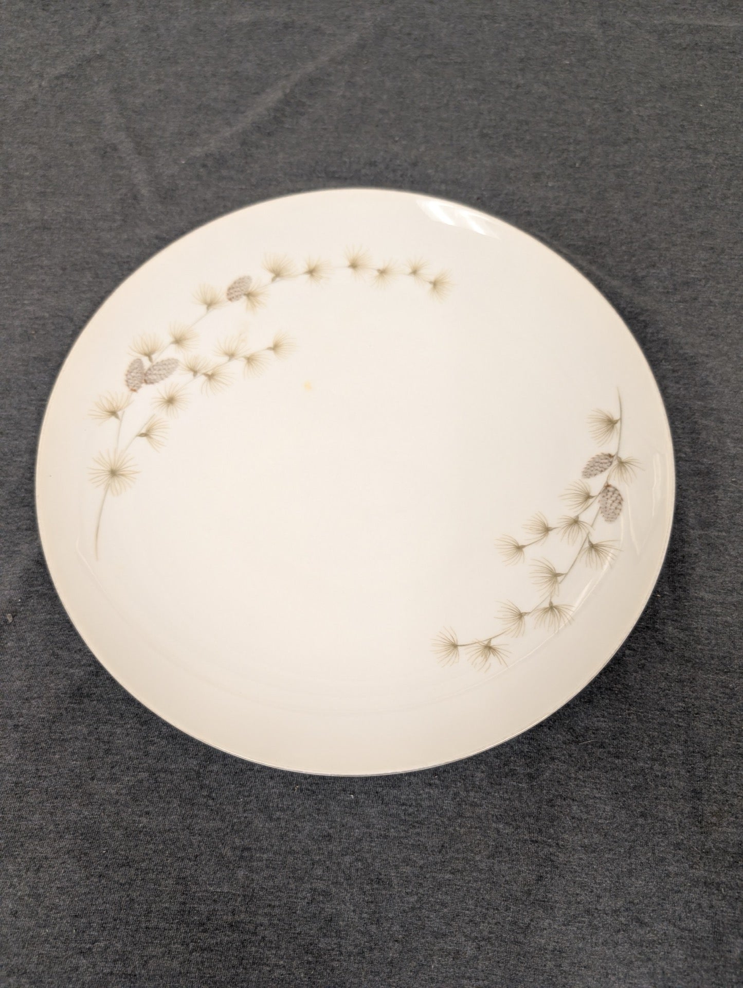 Top view of vintage Mikasa Sequoia 6141 plate with pine needle and cone design