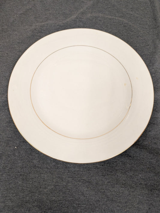 Top-down view of Sakura white plate with thin gold rim.