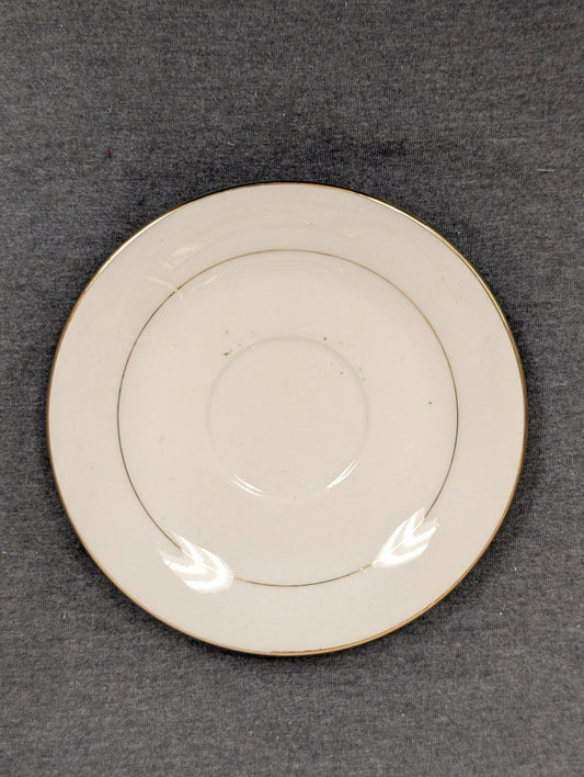 Top view of Sakura Classic Gold saucer with minor surface spots