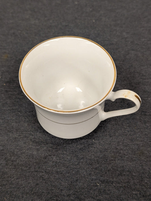 Sakura teacup showing visible brown staining and wear on the handle