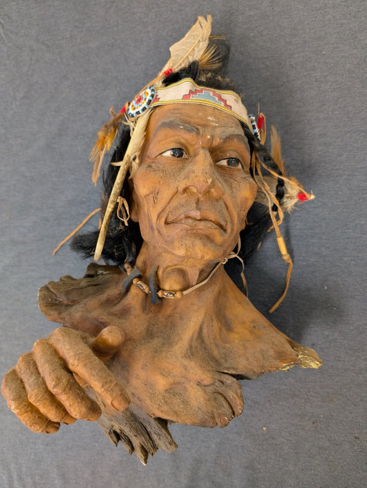 Detailed bust sculpture of a Native American chief with feathers and traditional garb