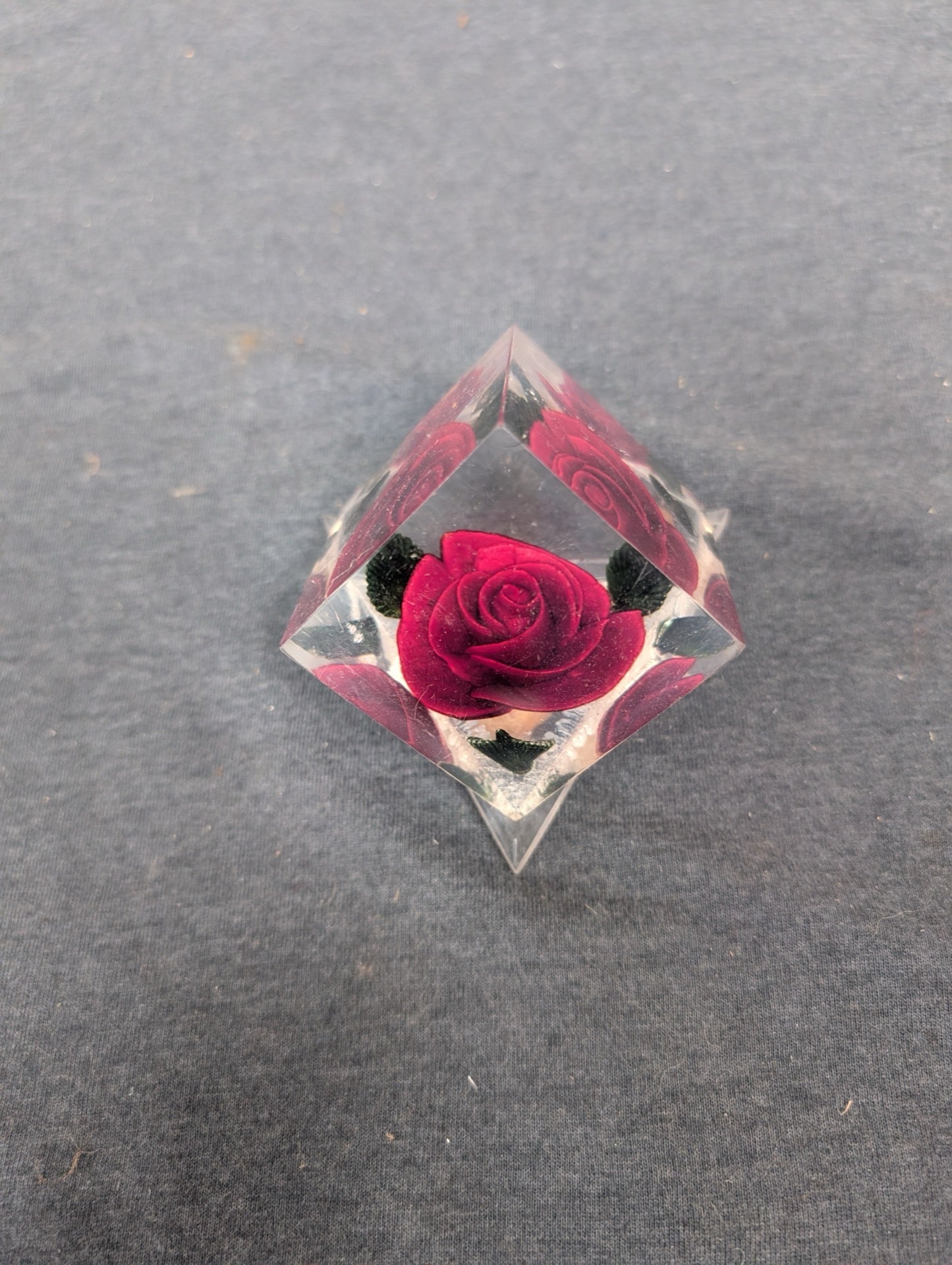 Clear acrylic pyramid paperweight with a 3D red rose carved inside