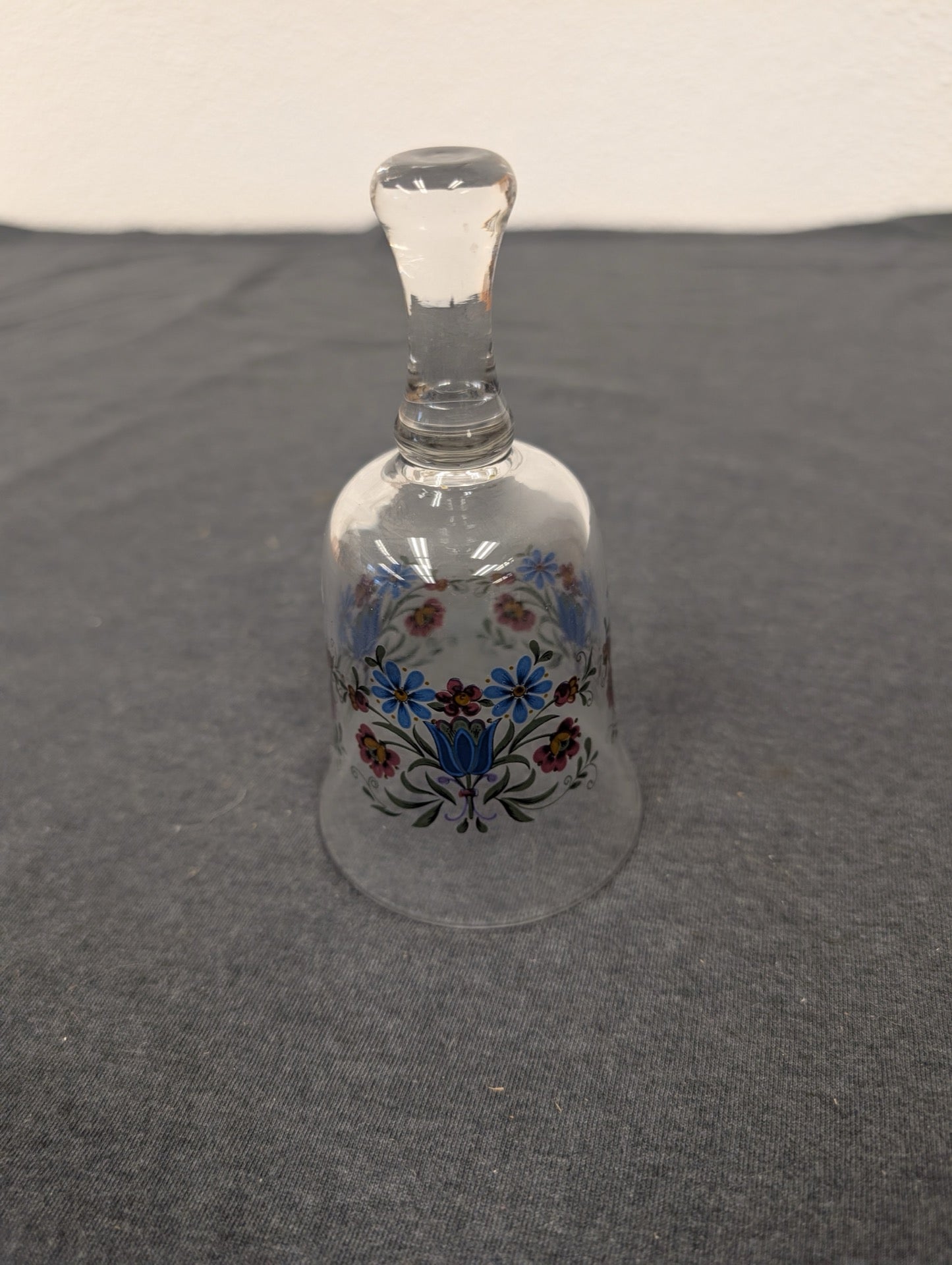 Clear glass bell with a painted floral garland of blue, pink, and yellow flowers.