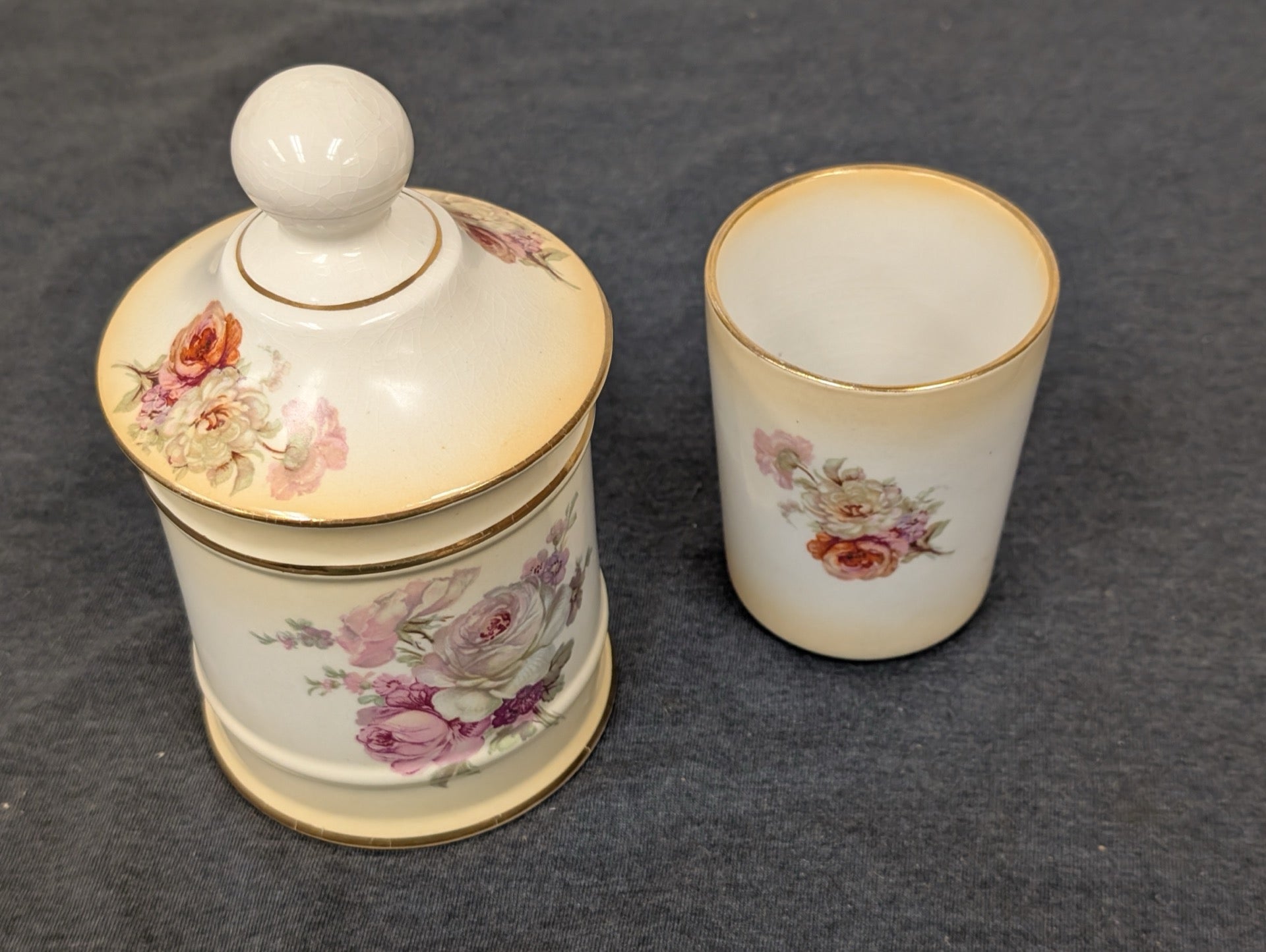 Vintage Old Foley ceramic floral lidded jar and matching cup on a gray background.