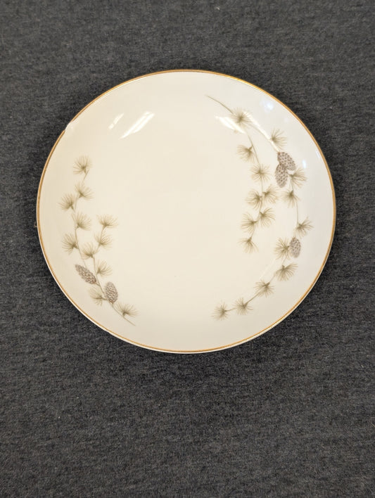 Front view of a Mikasa Sequoia plate displaying pine needles and gold trim