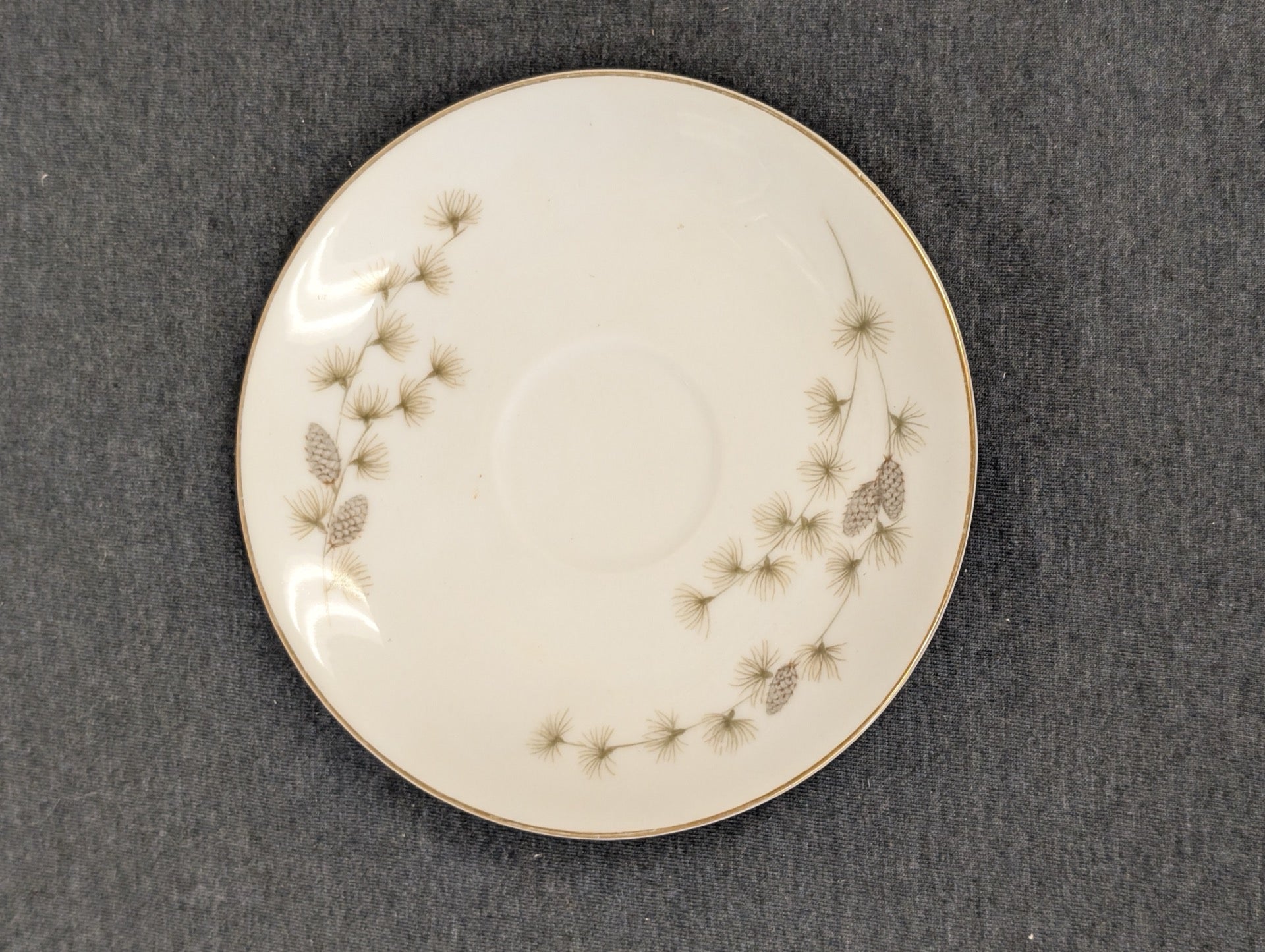 Top view of vintage Mikasa Sequoia saucer with pinecone detailing