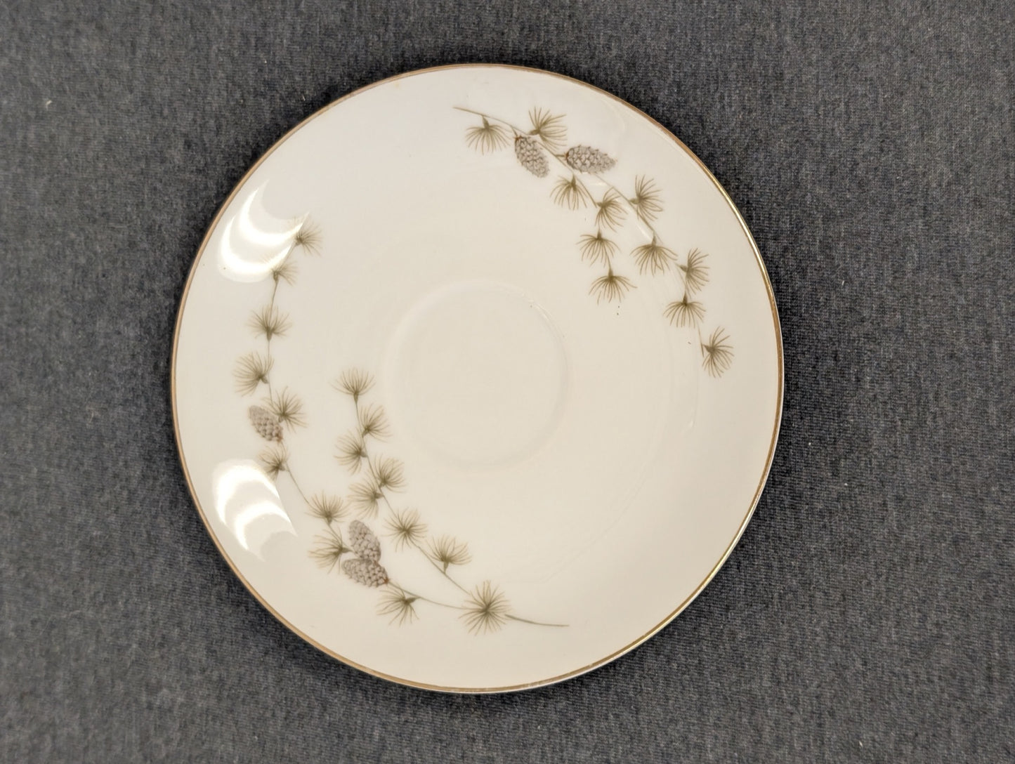 Retro Mikasa fine china saucer showing pine needle and pinecone motifs.
