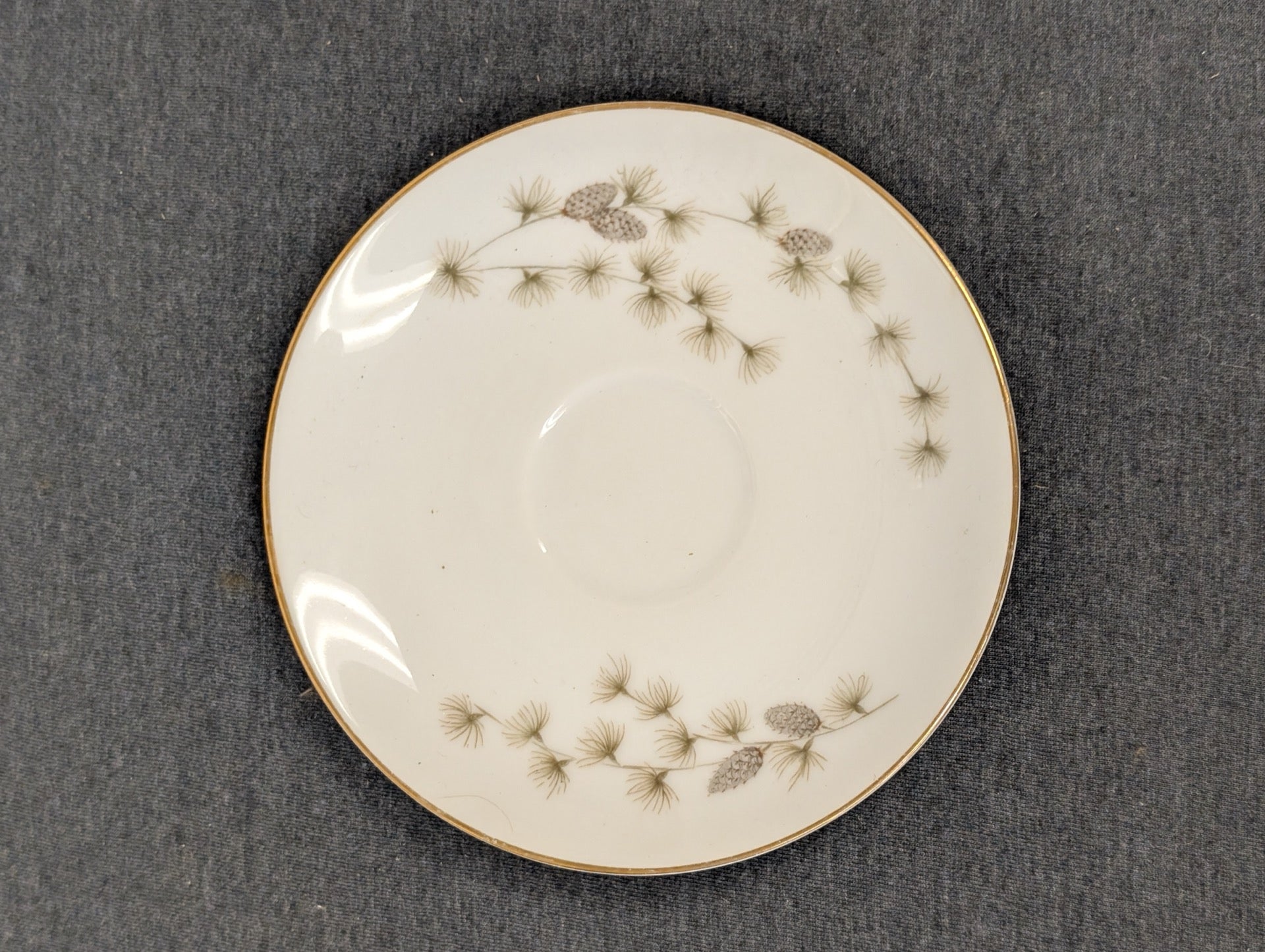 Pristine Mikasa fine china saucer showcasing elegant pinecones.