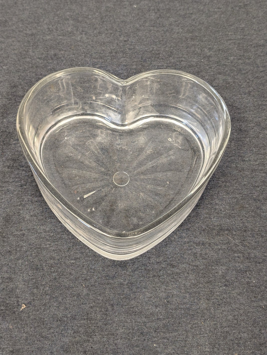 Clear glass heart shaped dish with starburst pattern inside