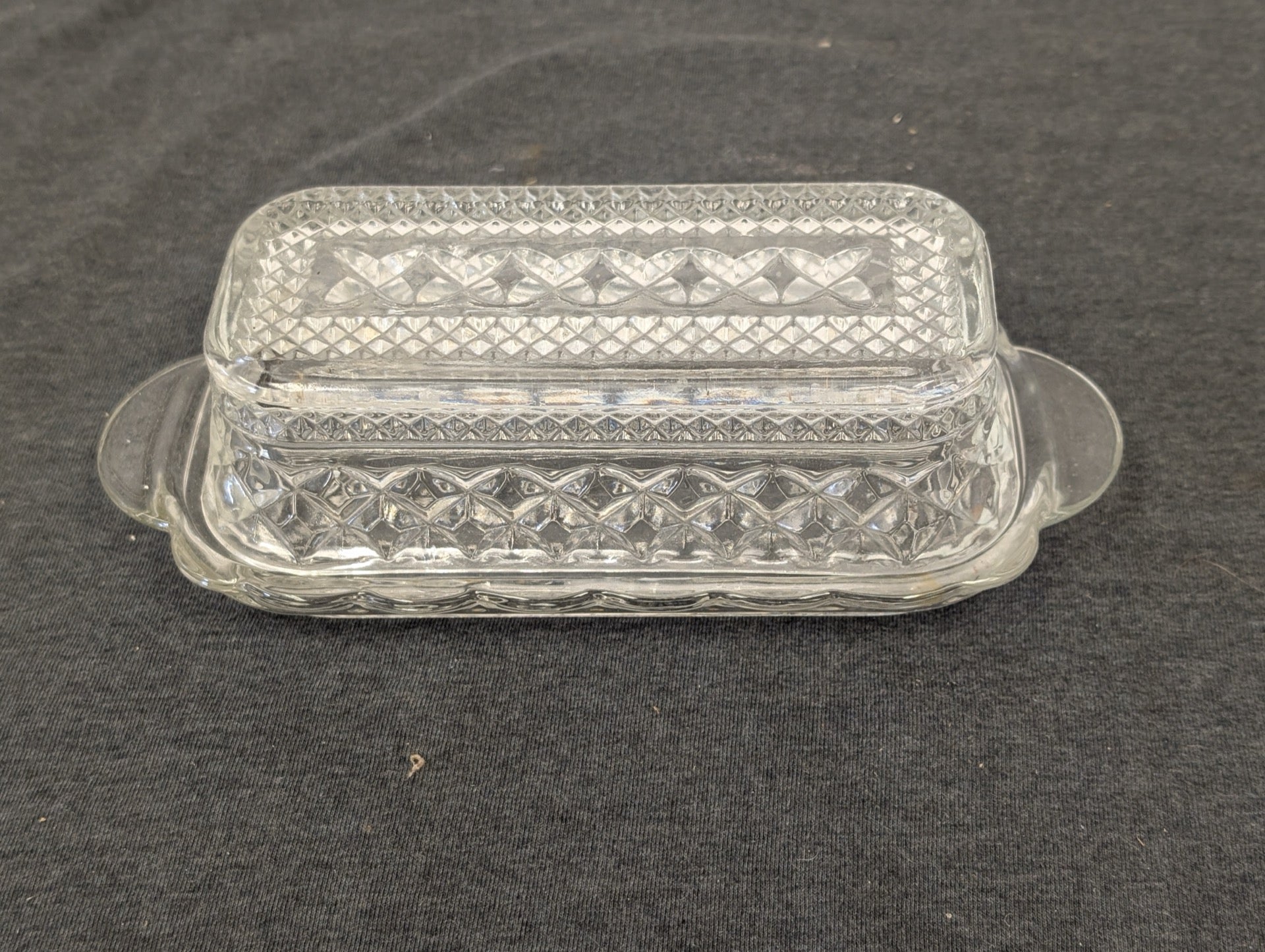 Clear glass rectangular butter dish with lid featuring a diamond pattern