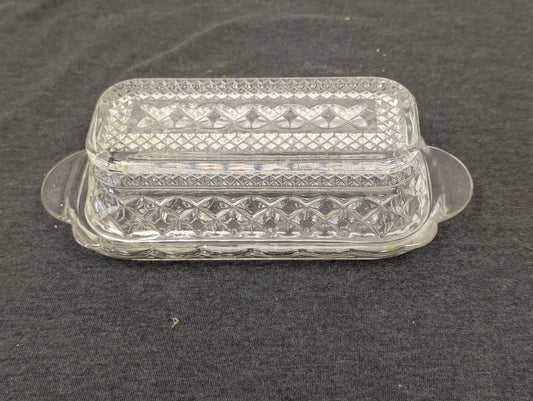 Clear glass rectangular butter dish with lid featuring a diamond pattern