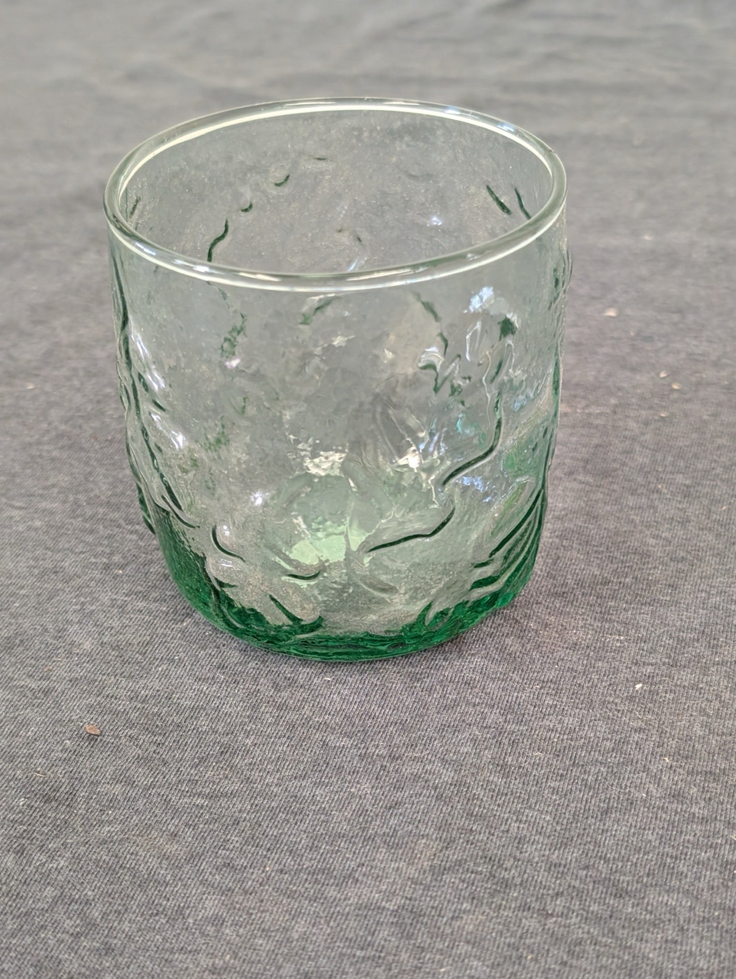 Short green glass tumbler with organic textured bark pattern