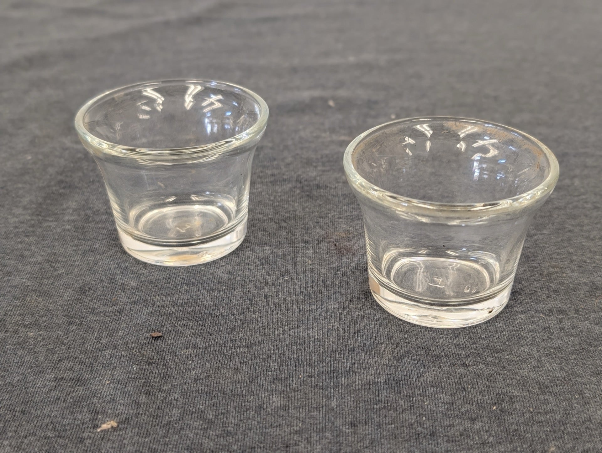 Two clear glass flared small cups suitable for votives or shots