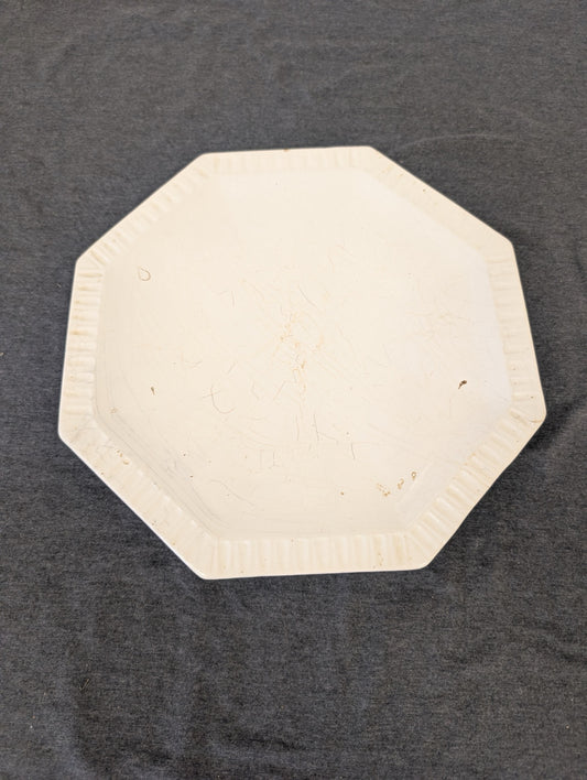 Antique white octagonal ironstone plate with heavy crazing and fluted edges.