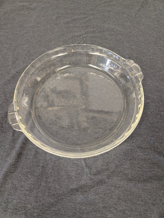 Clear glass pie plate with scalloped fluted edge and two small handles
