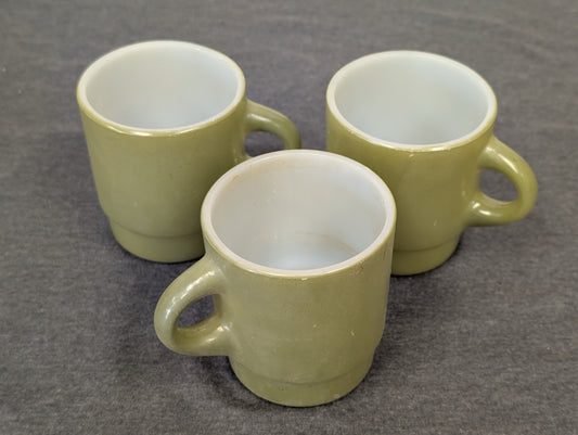 Three avocado green milk glass mugs in a stacking style