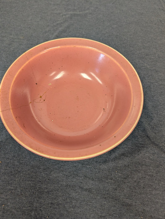 Pink ceramic bowl showing visible crack lines.