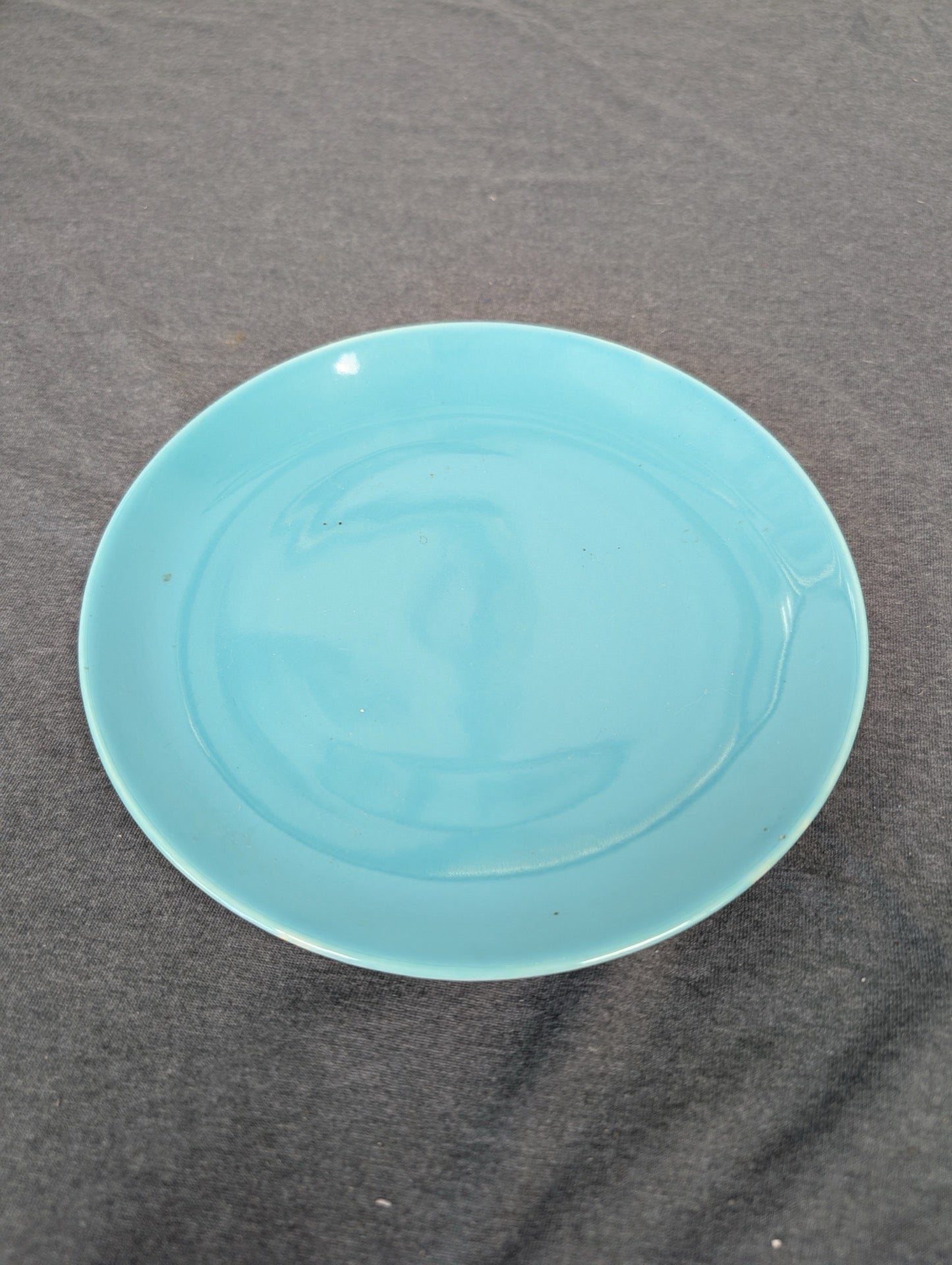 Solid teal blue ceramic shallow plate.
