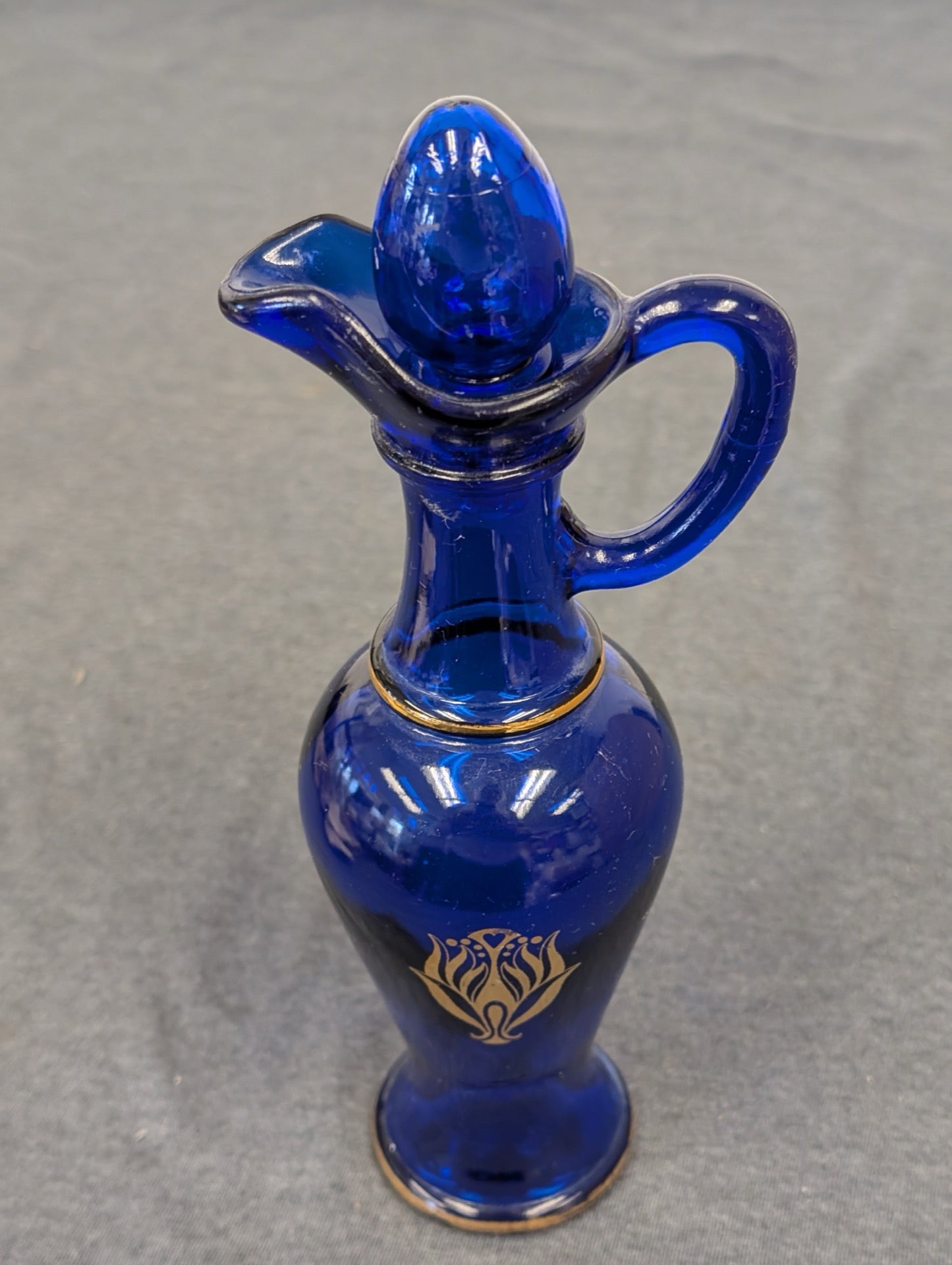 Vintage Avon Skin-So-Soft cobalt blue glass cruet bottle with glass stopper.