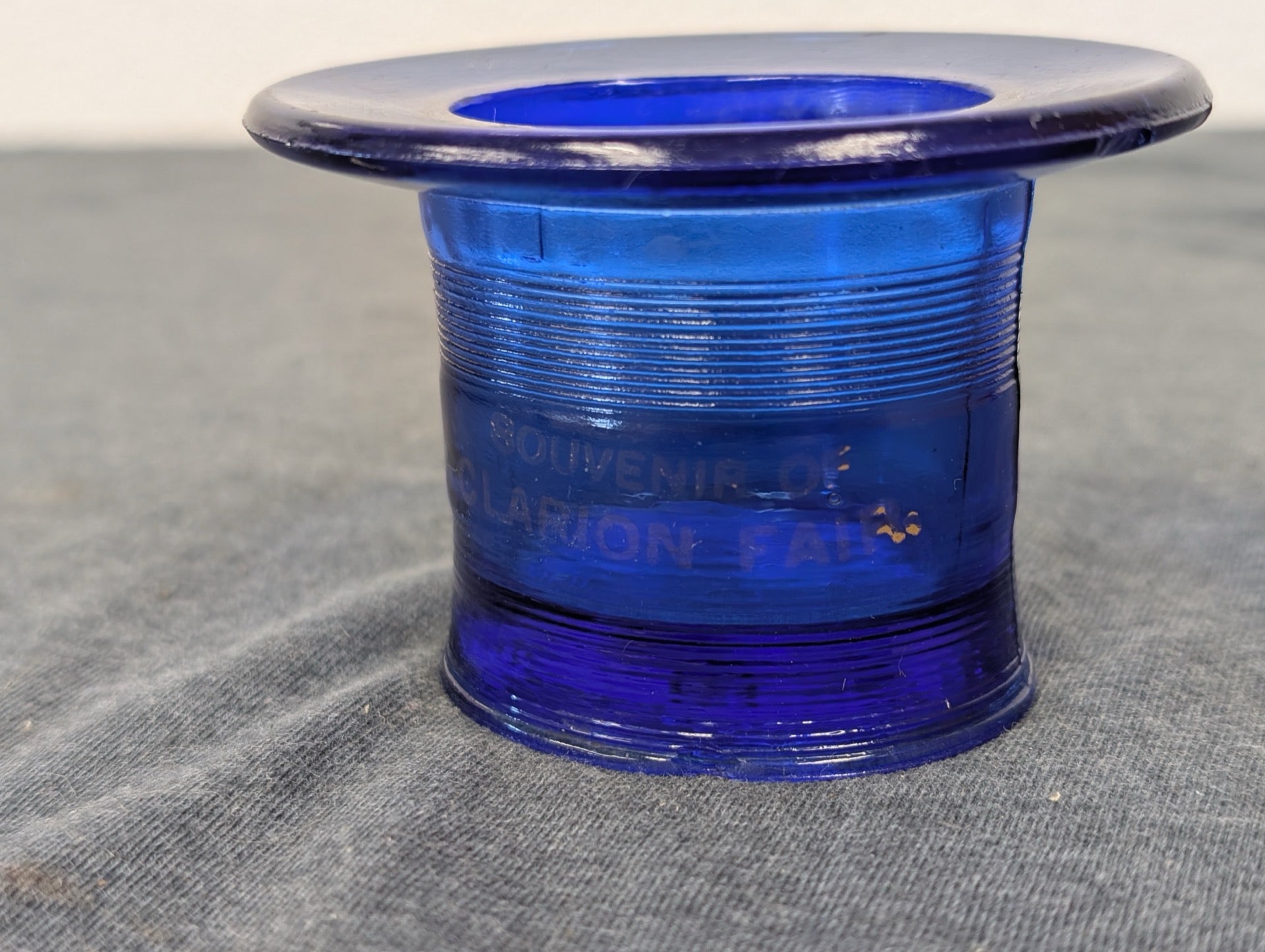 Cobalt blue glass top hat shape etched with Souvenir of Clarion Fair.