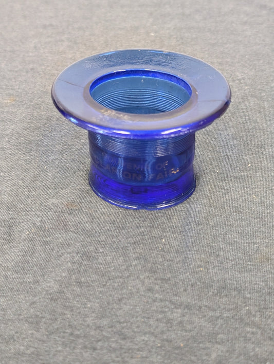 Top-down view into the hollow center of a cobalt blue glass souvenir hat.